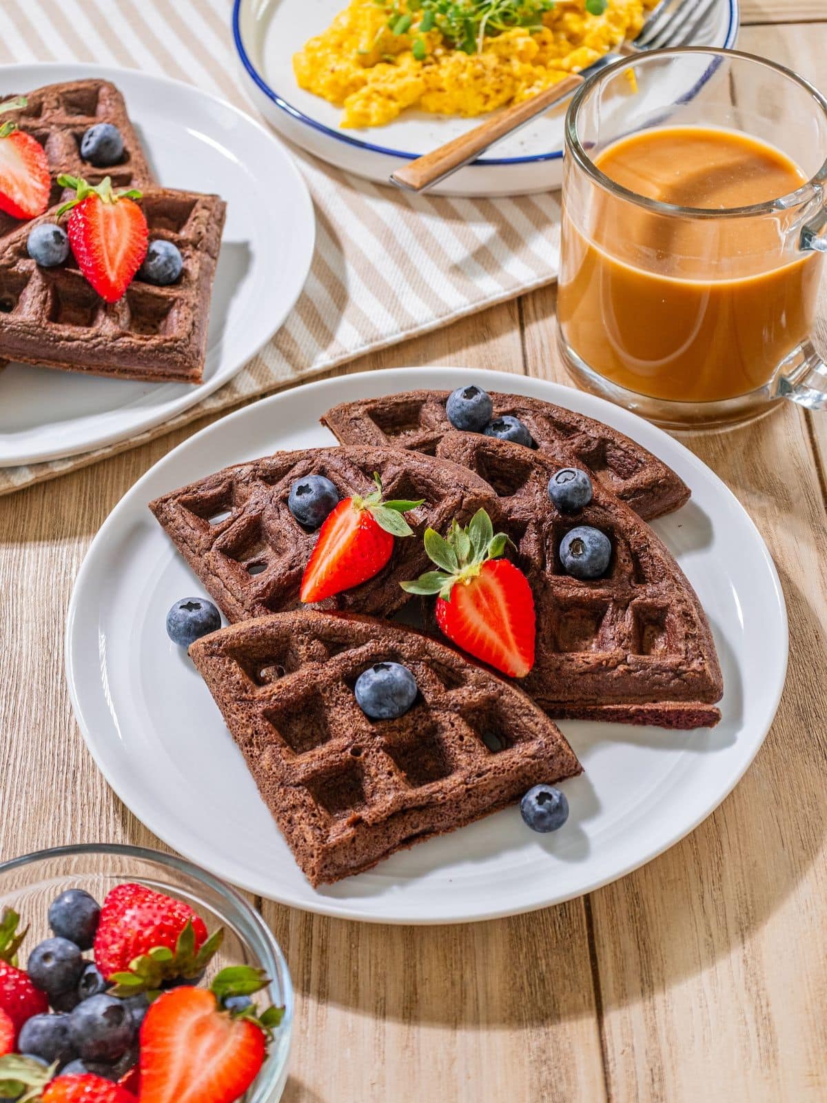 Chocolate waffles with strawberries on top.