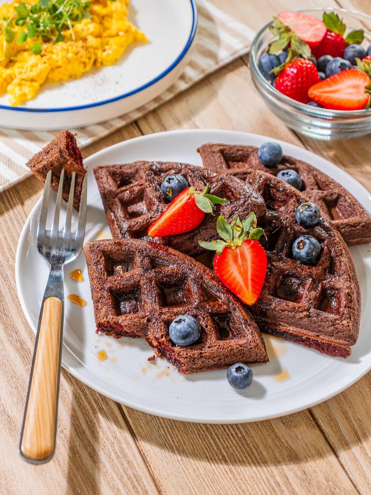 A fork taking a piece of chocolate waffle.