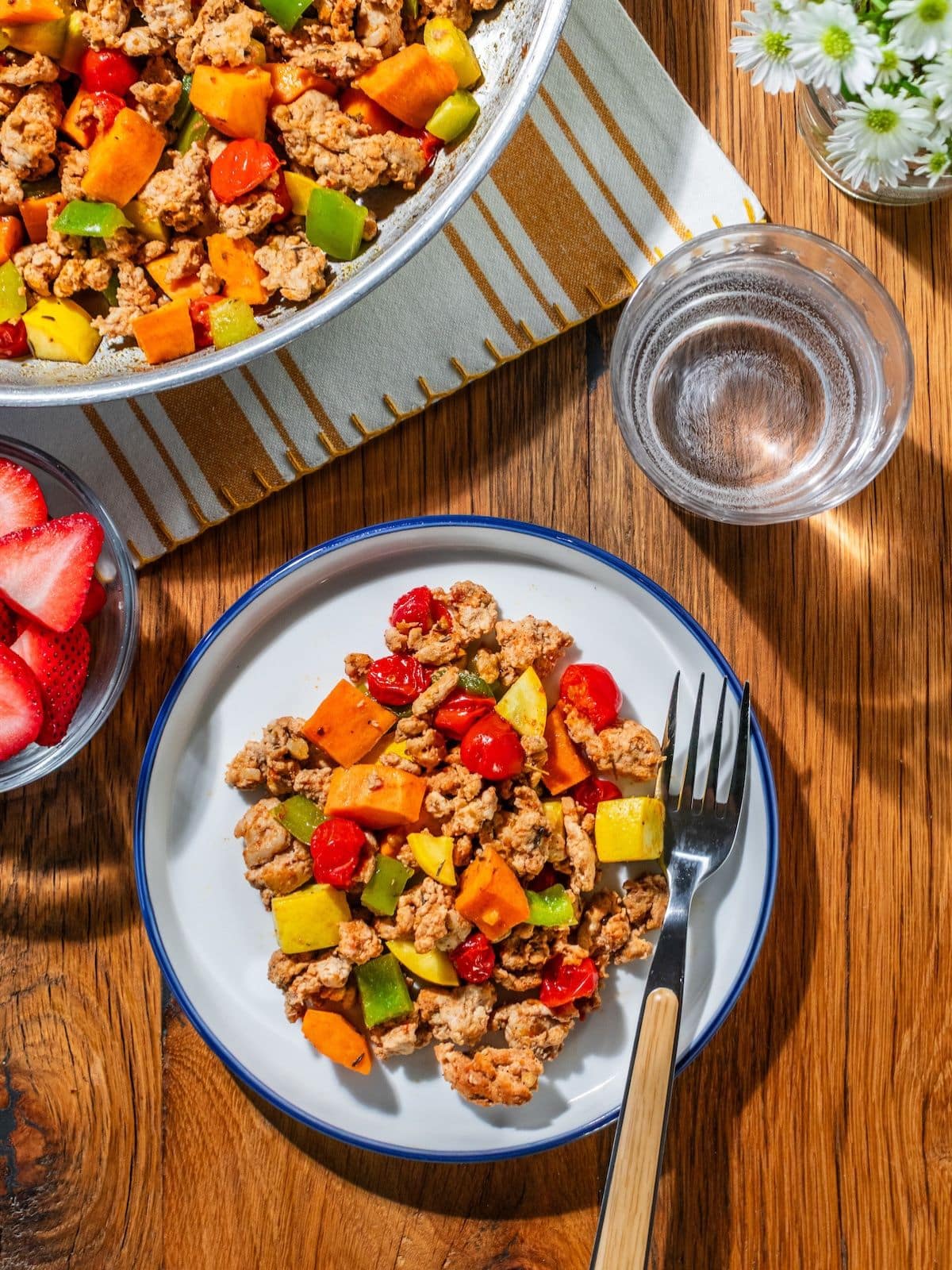 A plate with chorizo hash and a fork on the side.