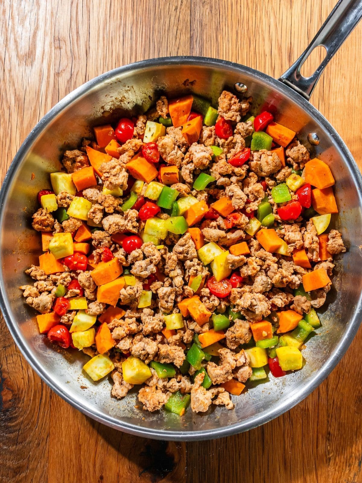Bell pepper, squash, and grape tomatoes added to the pan.
