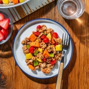 A fork beside some chorizo hash on a plate.