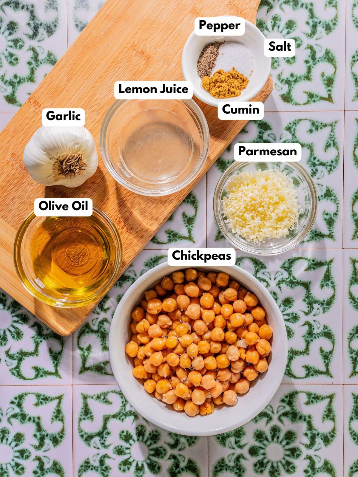 Ingredients to make this hummus in bowls on a table.