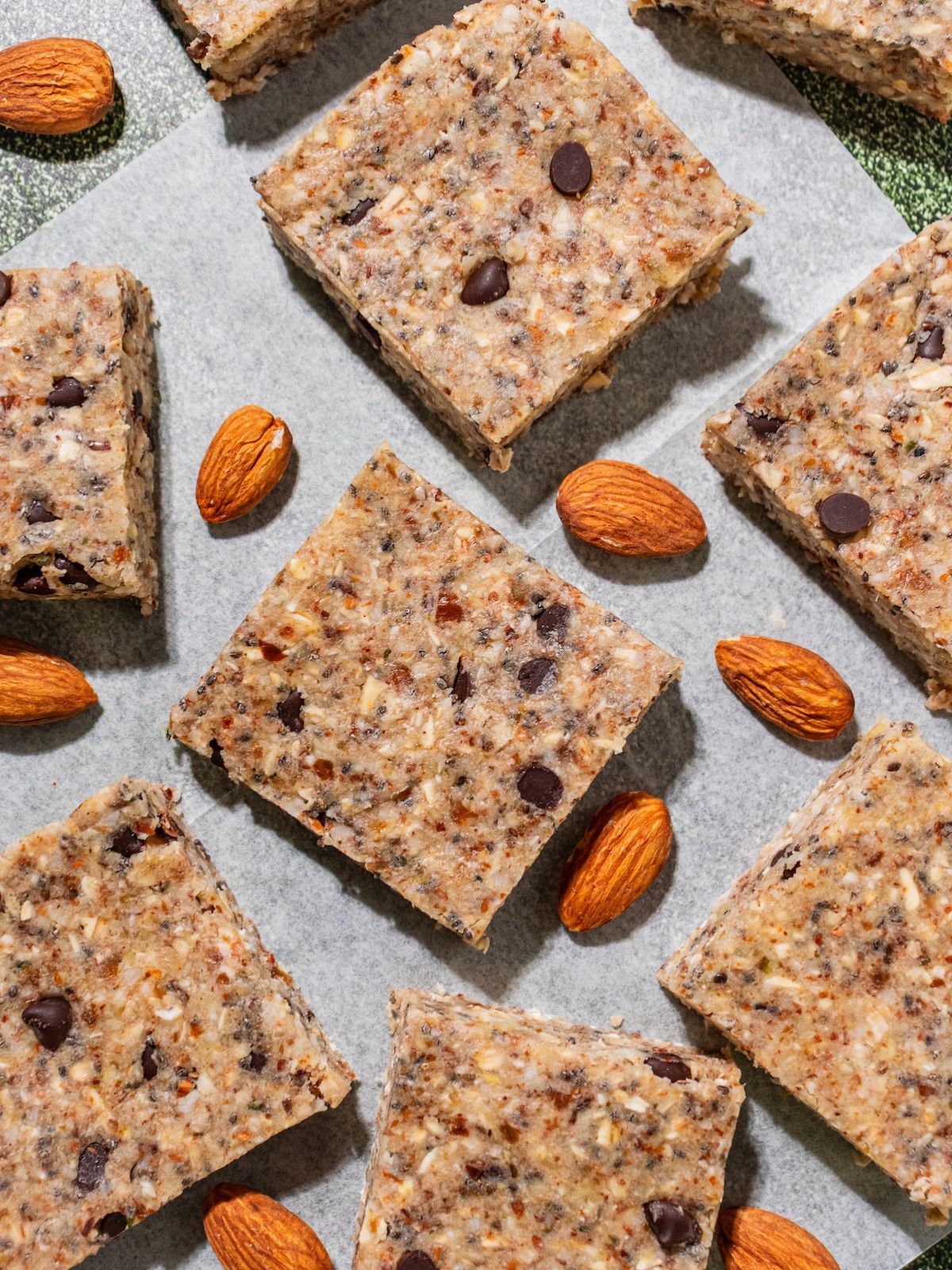 Granola bar squares on parchment paper.