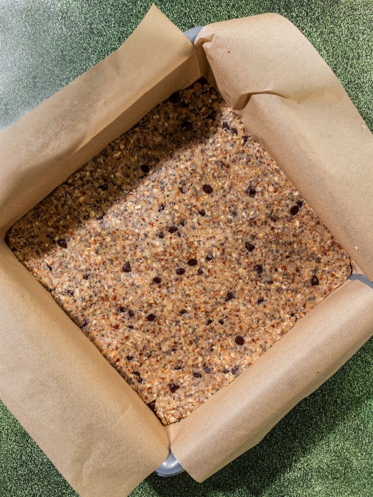 The granola bar mixture pressed into a baking dish.