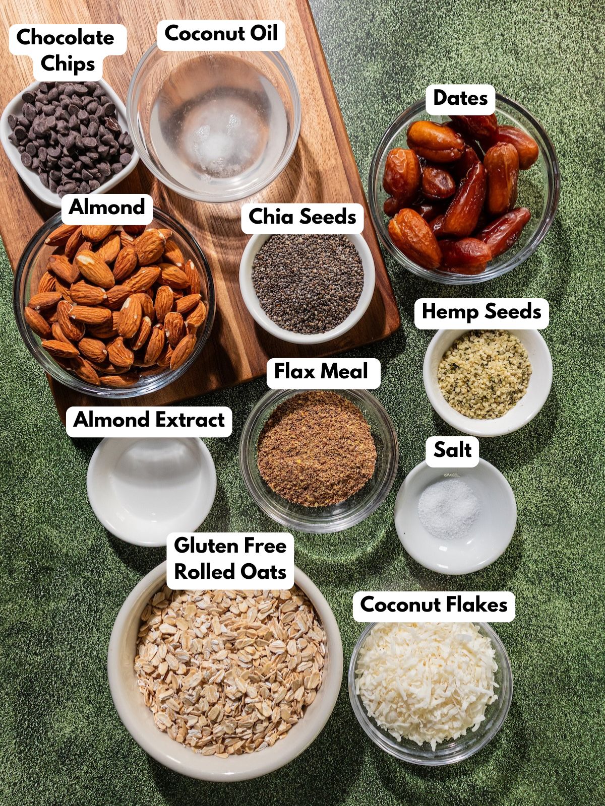 Ingredients to make these gluten-free snack bars in bowls on a table.