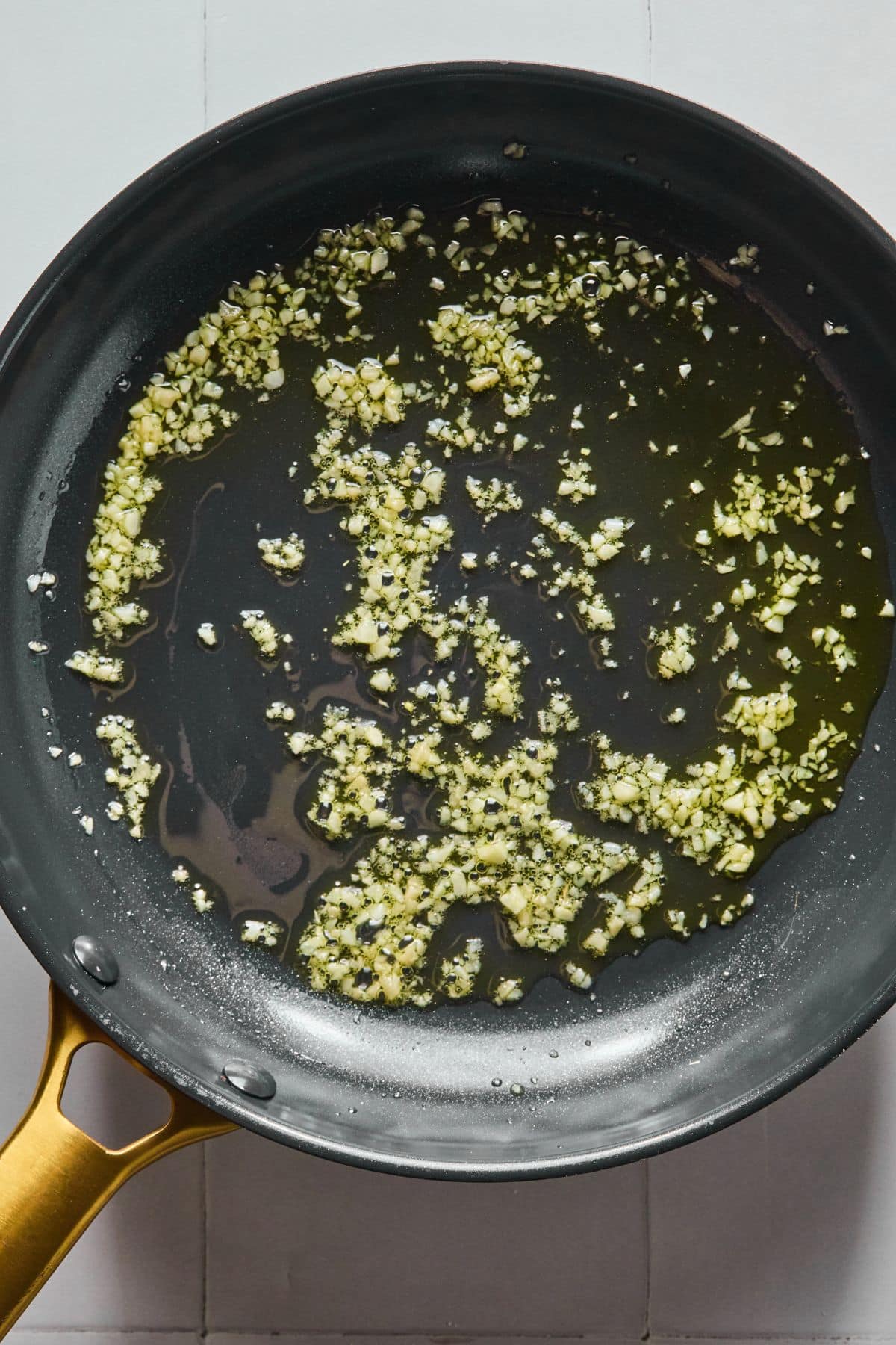Garlic and ginger cooking in a pan.