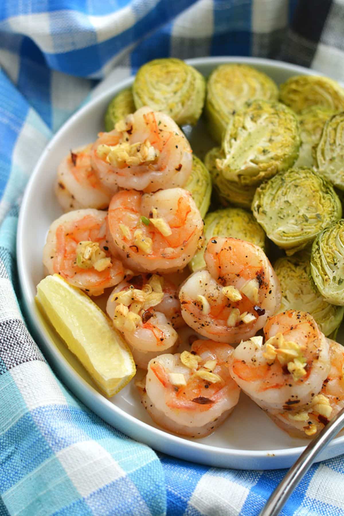 Sheet pan shrimp and brussels sprouts on a plate.