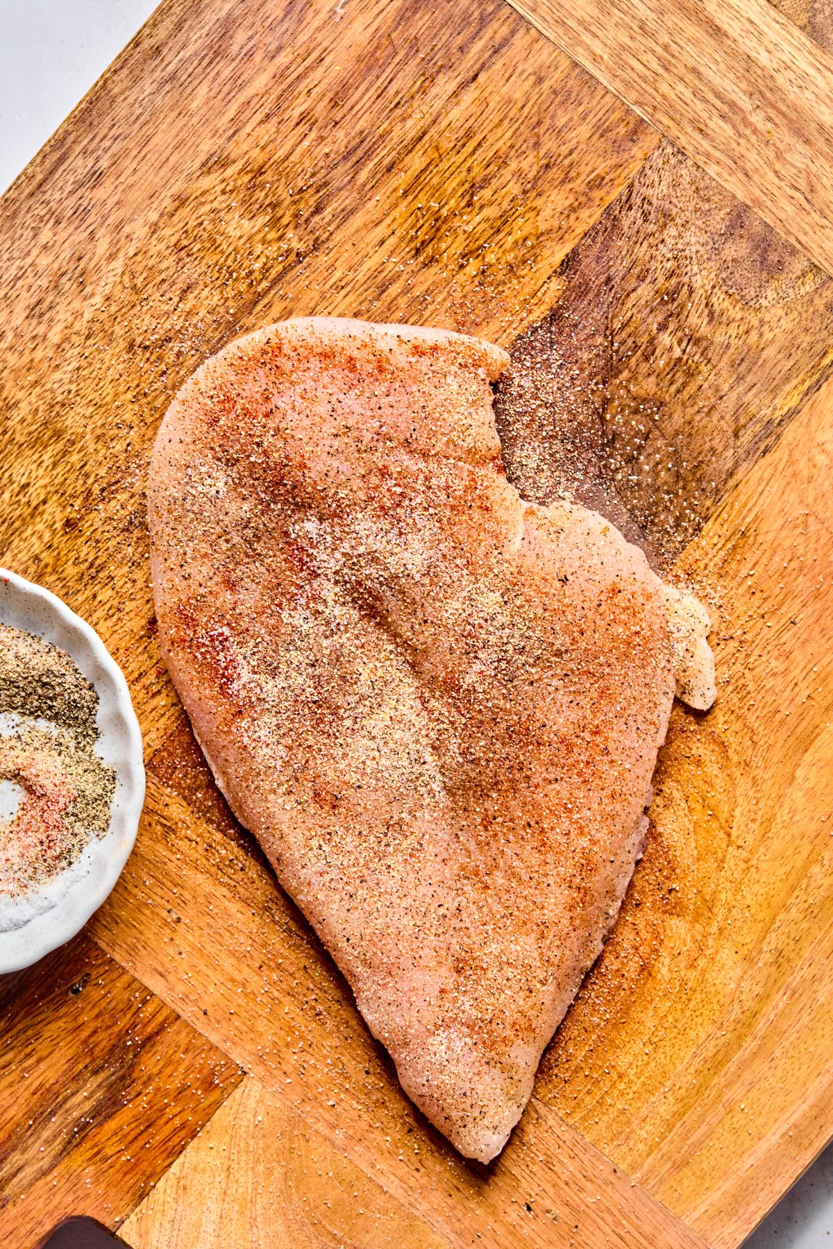 Chicken with spices on it.