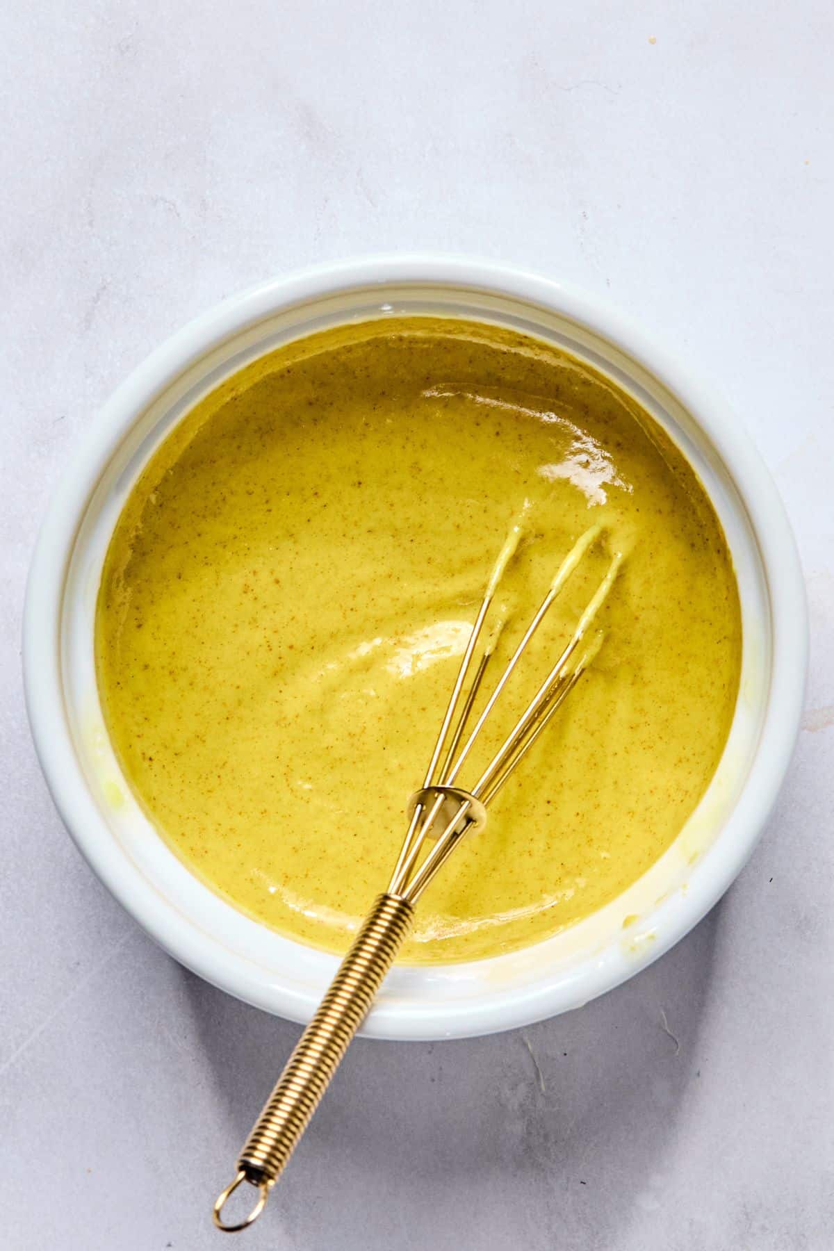 Sauce being mixed in a bowl.
