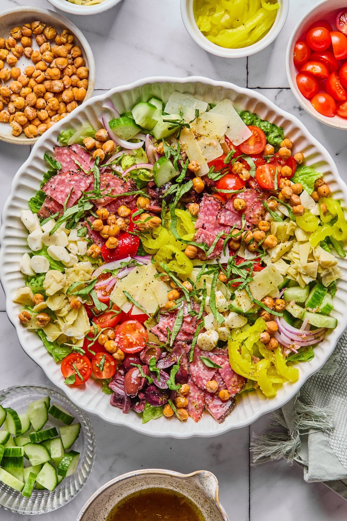 The dressing added to the salad, and mixed together, then topped with basil.