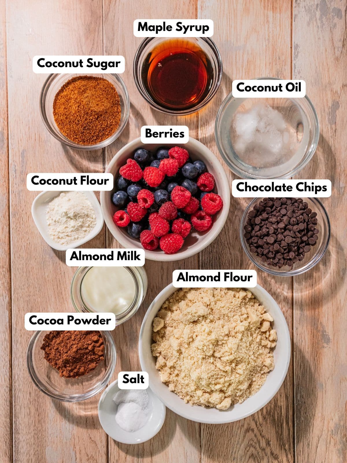 Ingredients to make these gluten-free berry bars in bowls on a table.