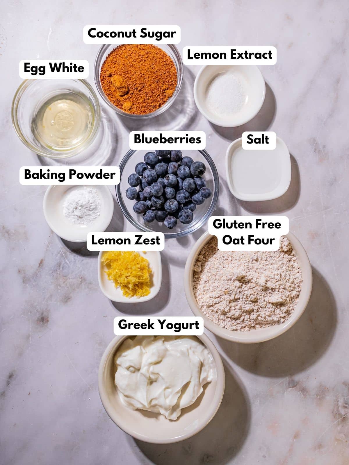 Ingredients to make these healthy blueberry cookies in bowls on a table.