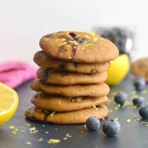 Healthy blueberry cookies stacked on a table.