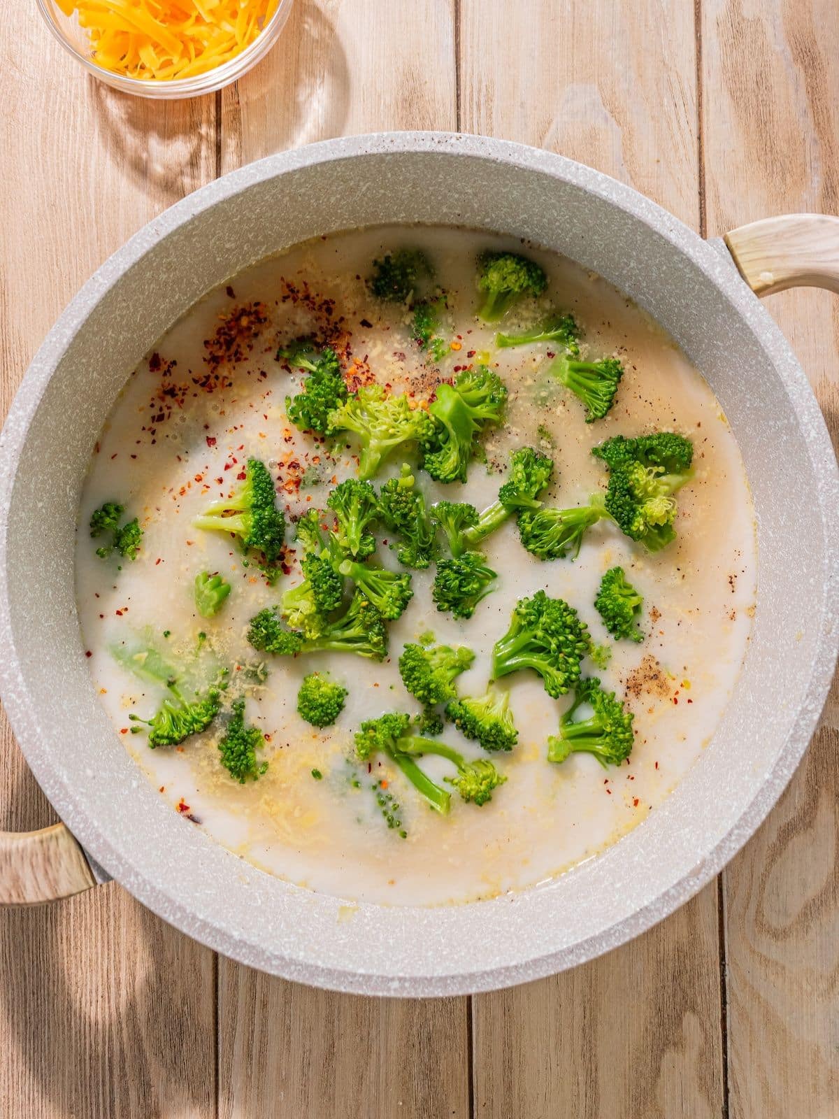Broccoli, leeks and garlic, vegetable broth, half and half, salt, pepper and red pepper flakes added into the pot.