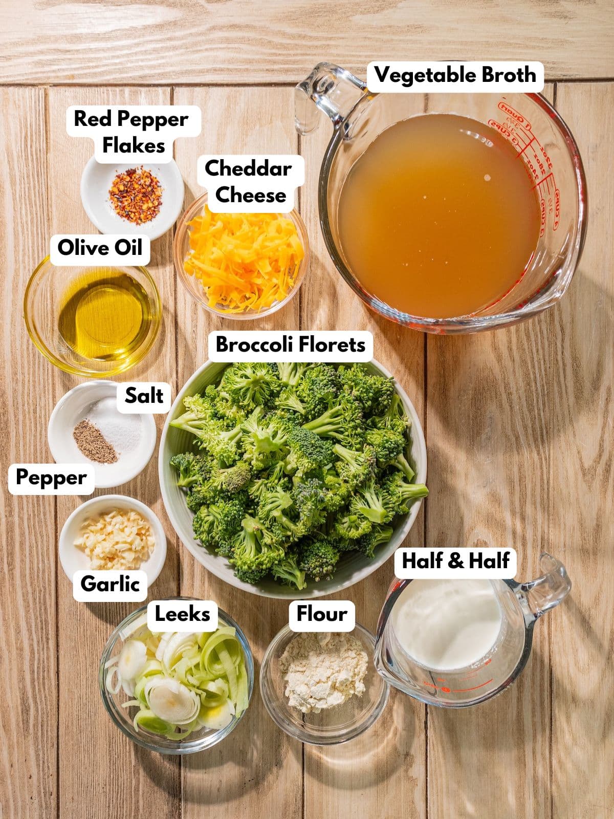 Ingredients to make this healthy broccoli soup in bowls on a table.