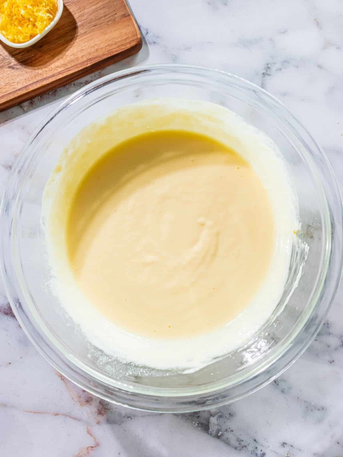 The lemon bar filling ingredients in a bowl mixed together.