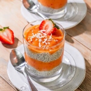 Mango chia pudding with a strawberries on top.