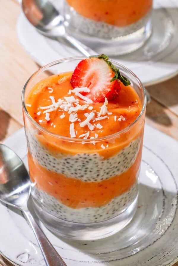 Mango chia pudding with a strawberries on top.