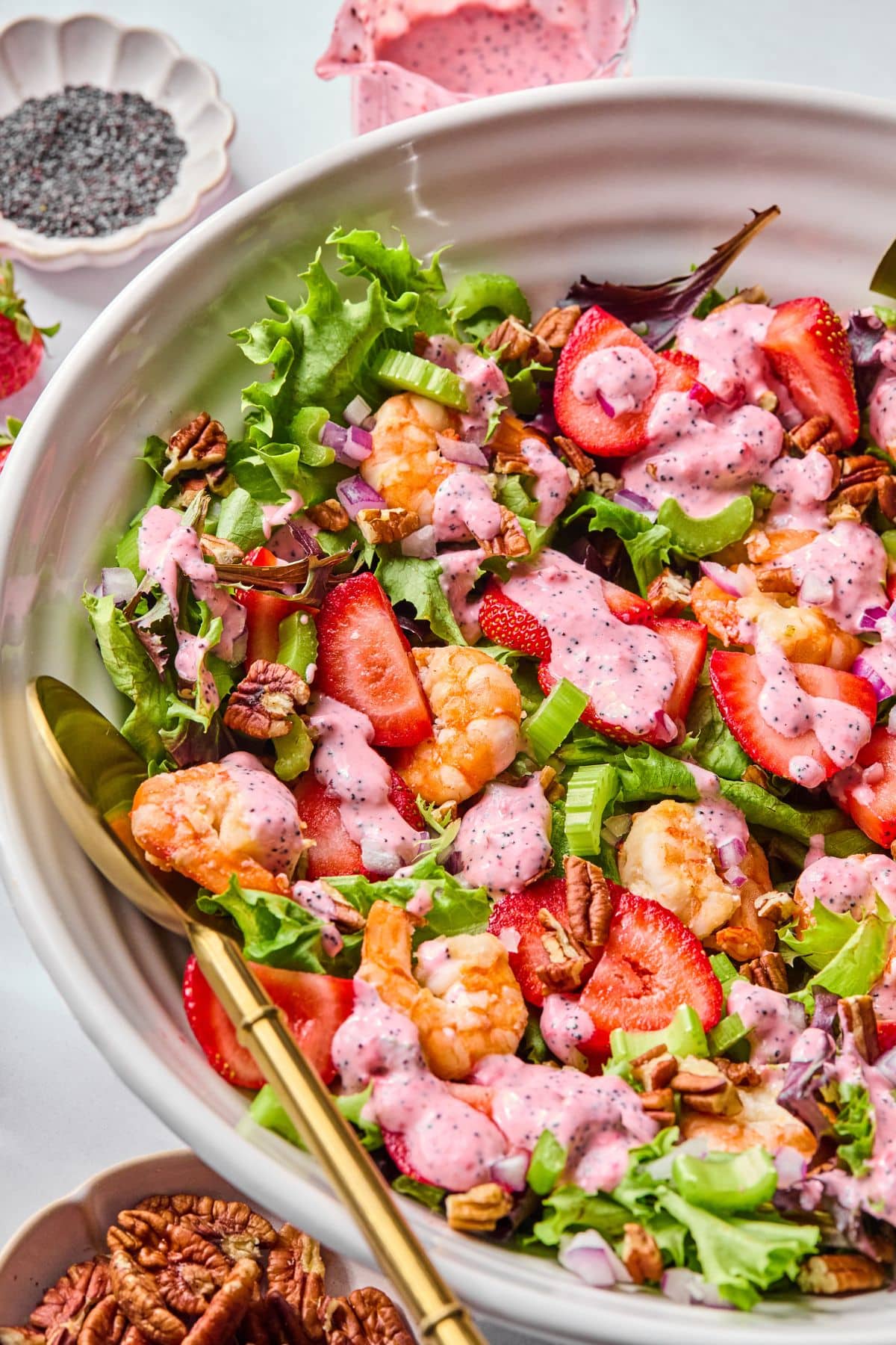 A bowl with with shrimp salad with strawberries.