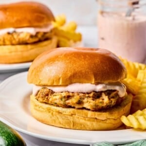 Zucchini turkey burgers on a plate with a side of fries.