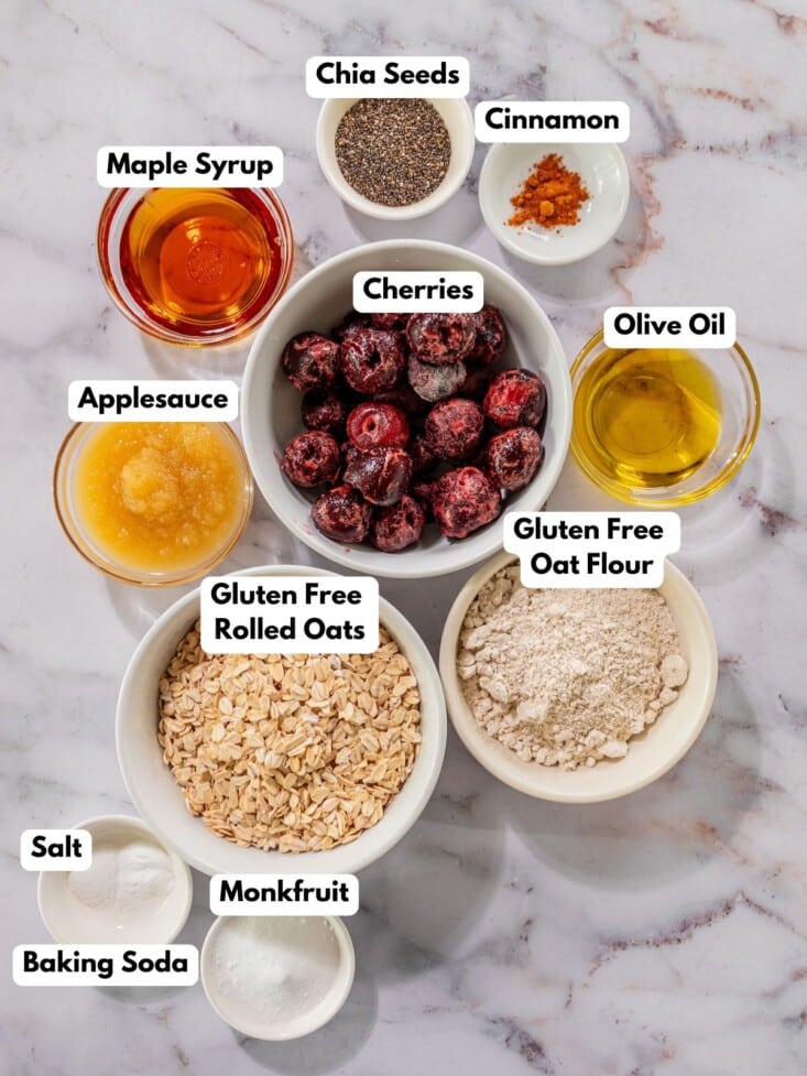 Ingredients to make healthy cherry bars in bowls on a table.
