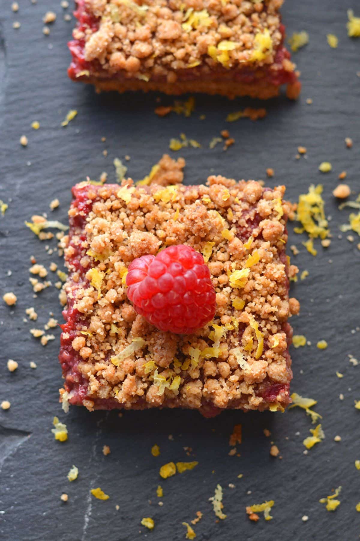 A raspberry bars with a raspberry on top.