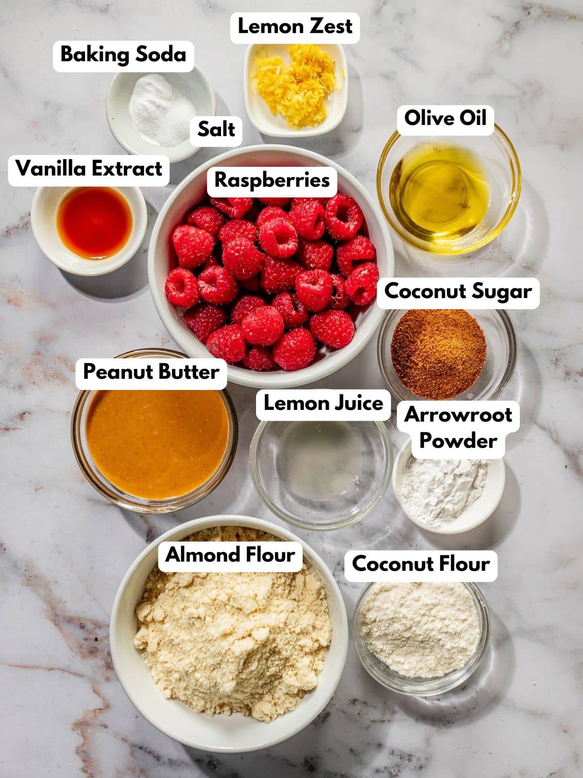 Ingredients to make these healthy raspberry bars in bowls on a table.