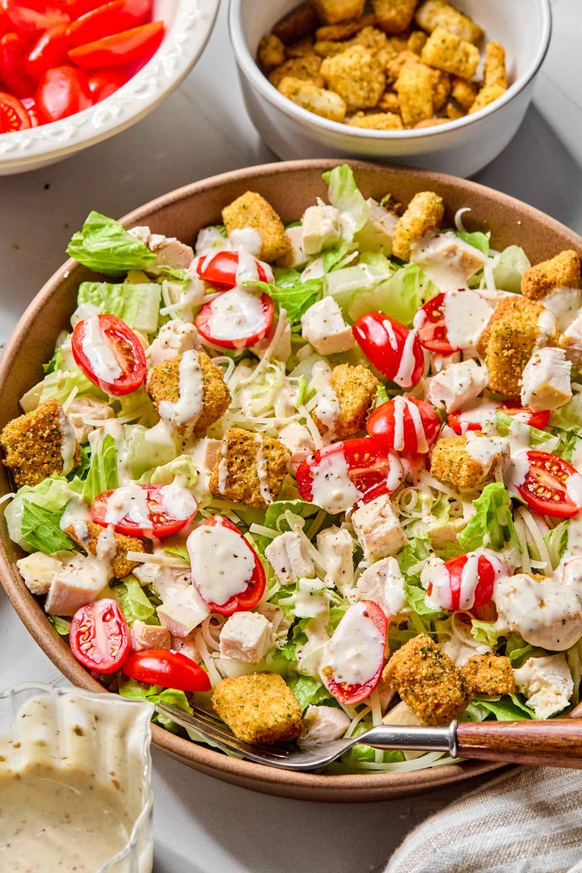 A large bowl of chicken caesar salad.