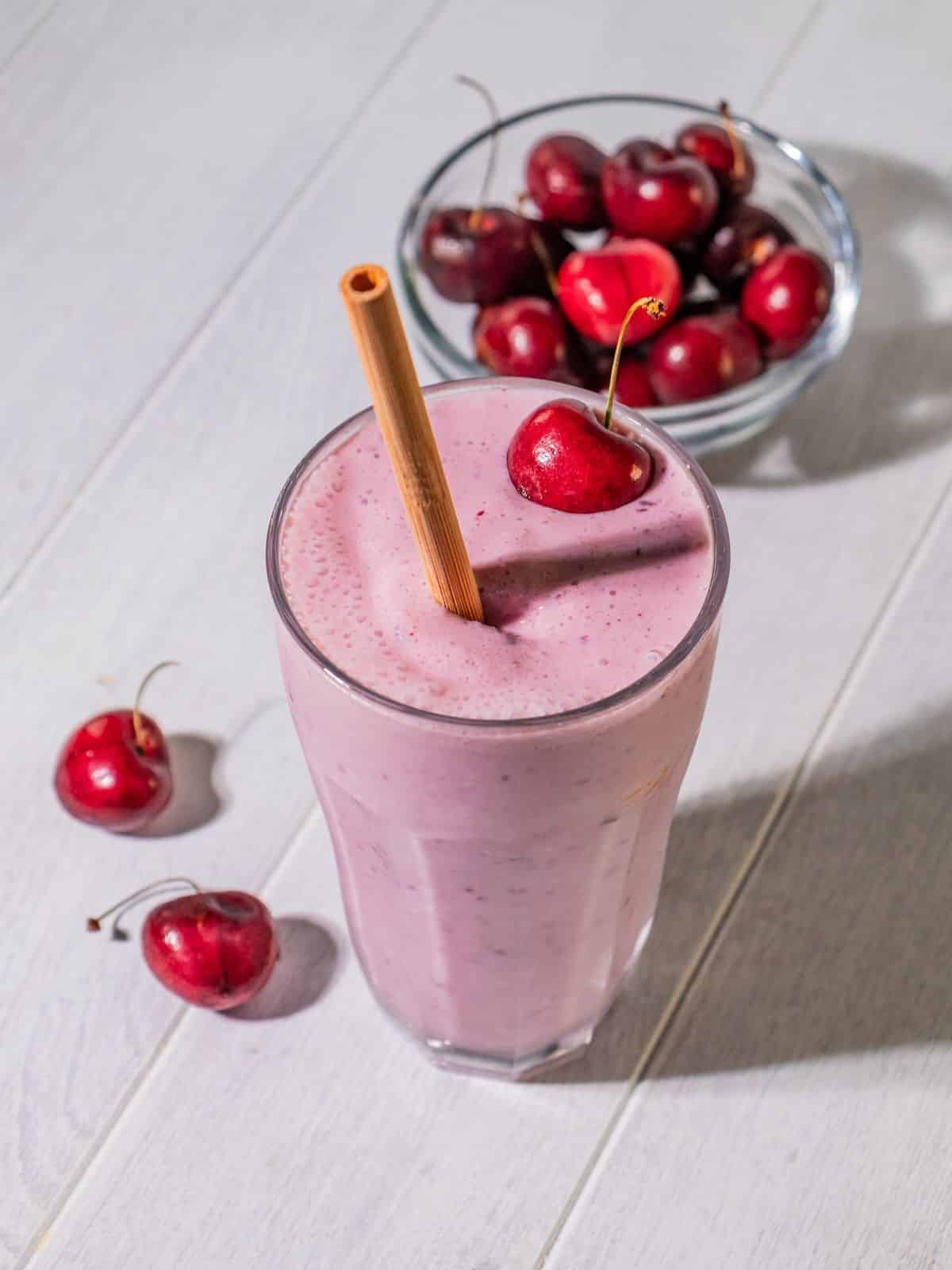 Healthy cherry smoothie in a glass on a table.