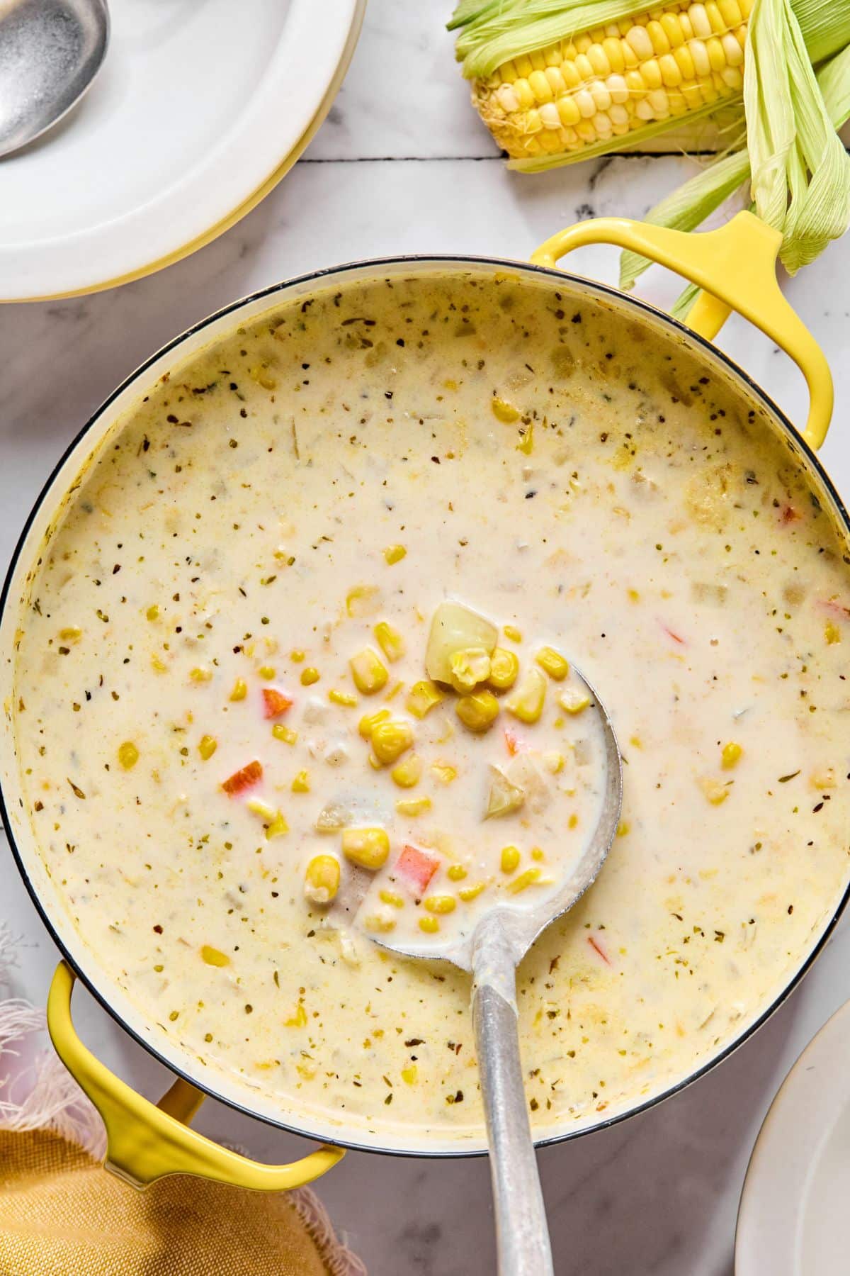 Cream and corn added to the pot to cook.