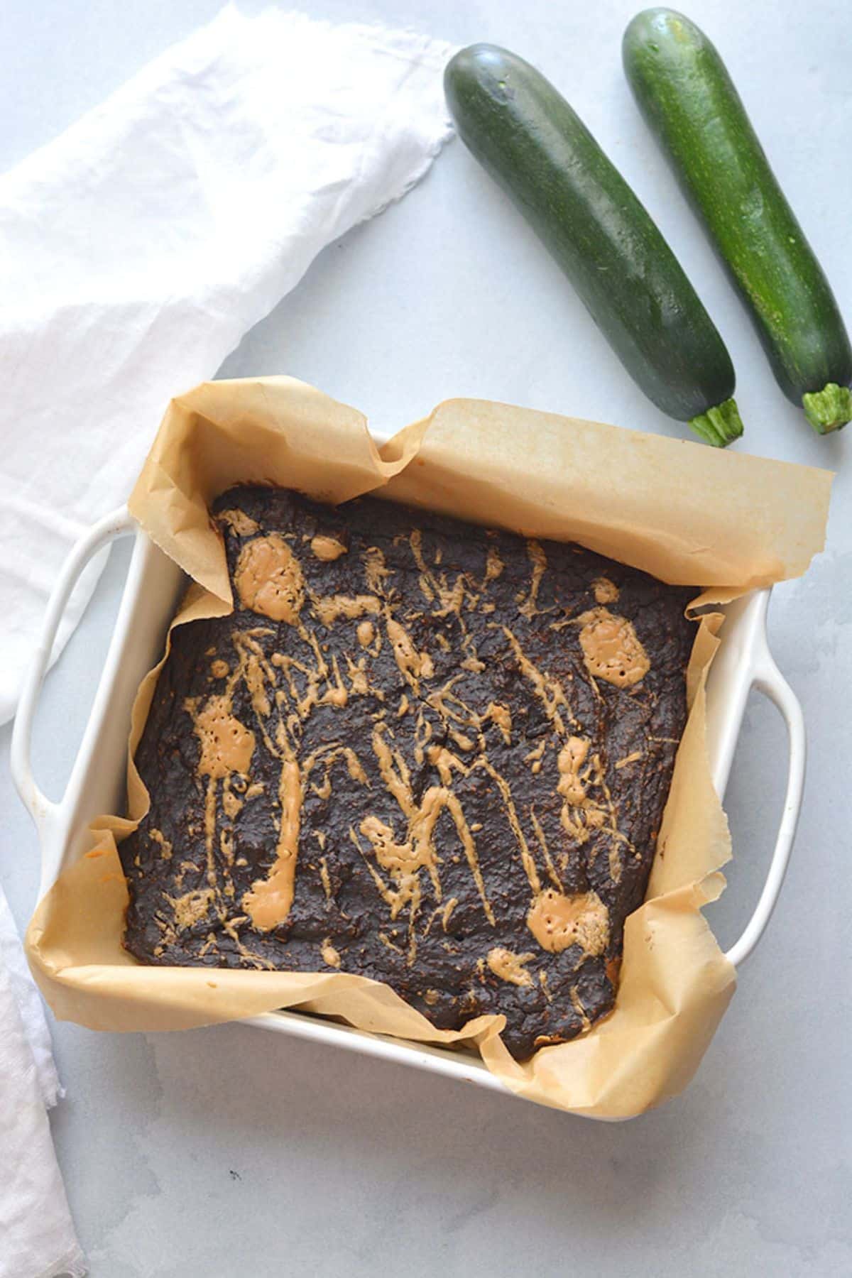 Zucchini brownies on parchment paper.