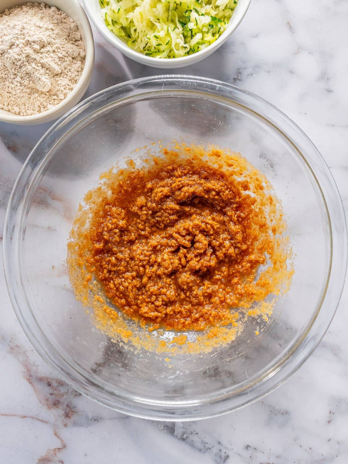 Almond butter, applesauce, maple syrup and vanilla mixed in a bowl.