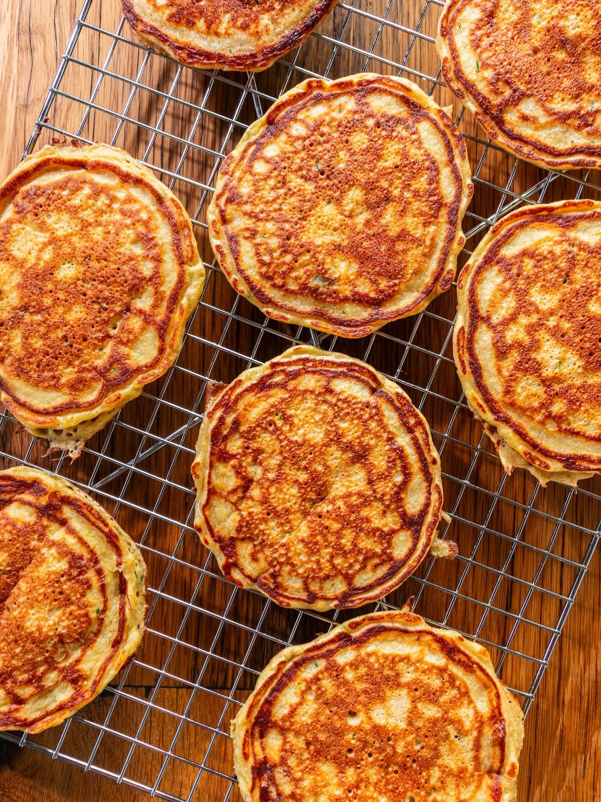 Pancakes cooling on a wire rack.
