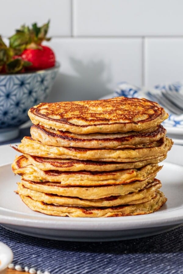 A stack of zucchini pancakes on a plate.