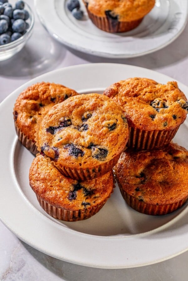 Sour cream blueberry muffins on a plate.