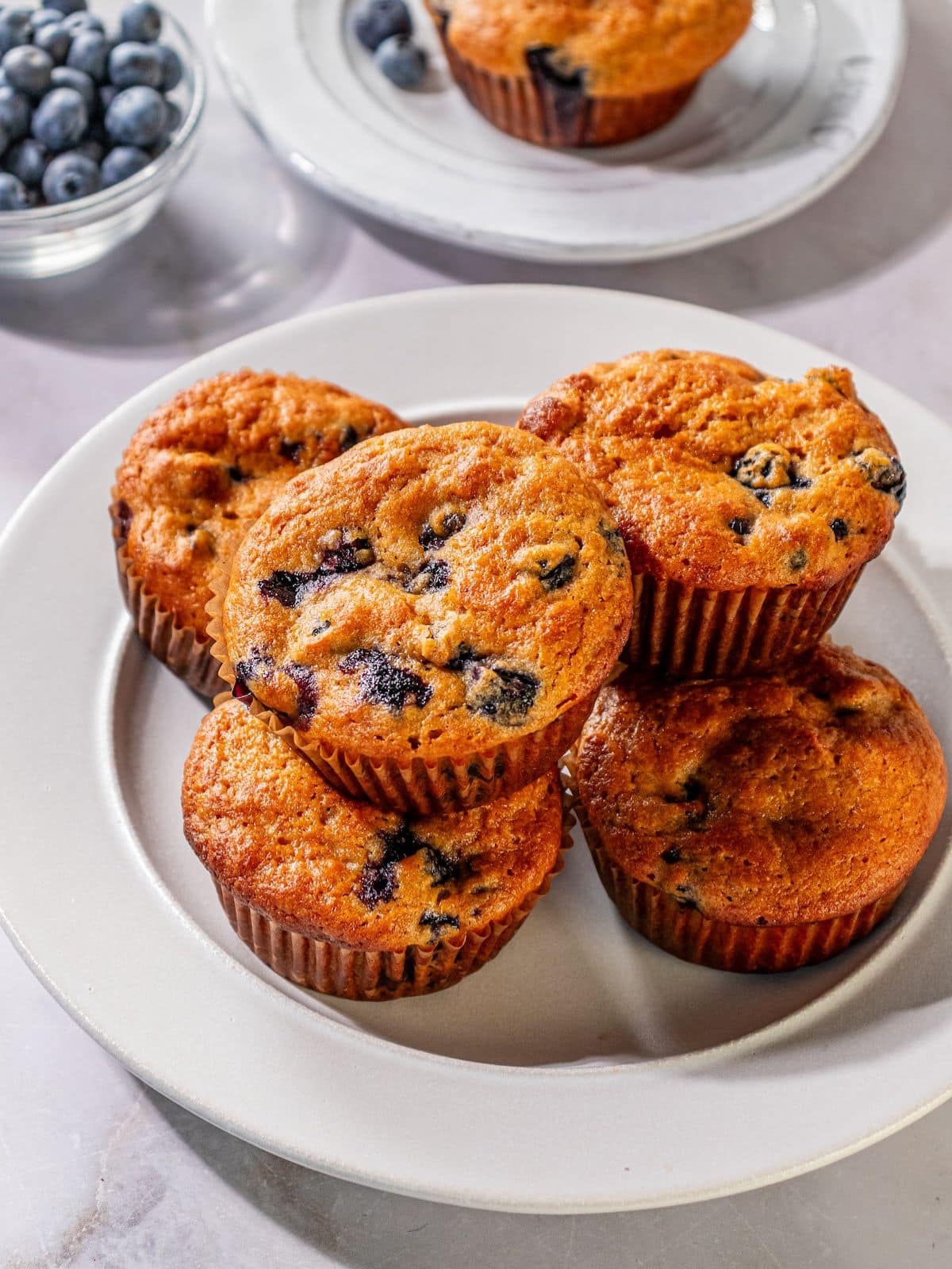 Sour cream blueberry muffins on a plate.