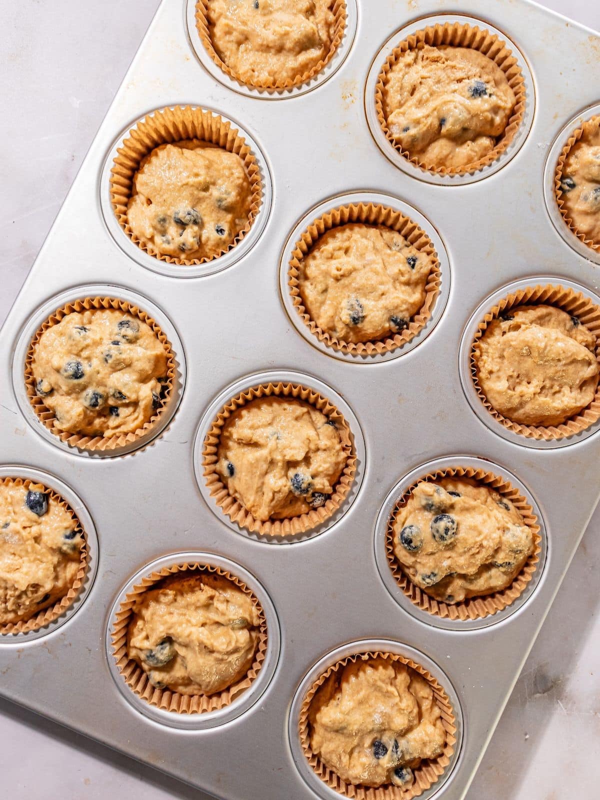 The batter poured into a muffin tin.