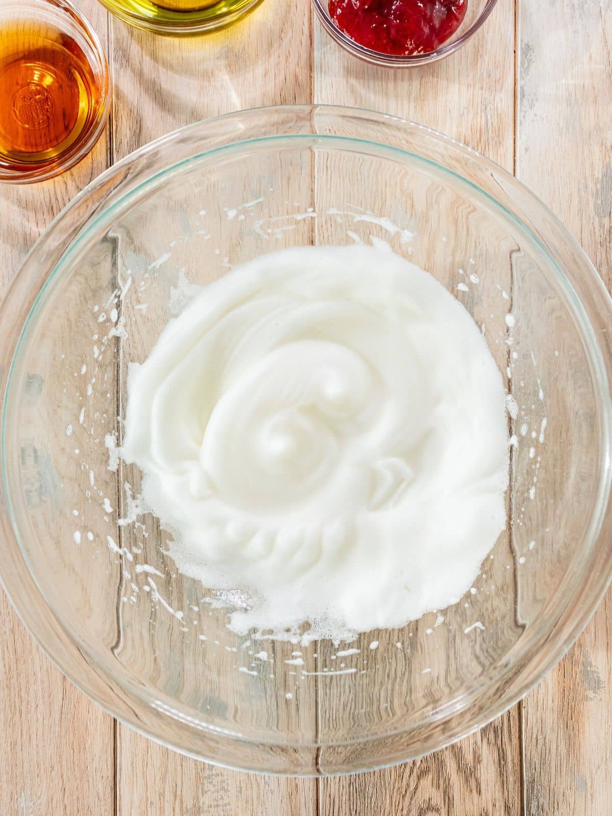 Egg whites beaten in a bowl.