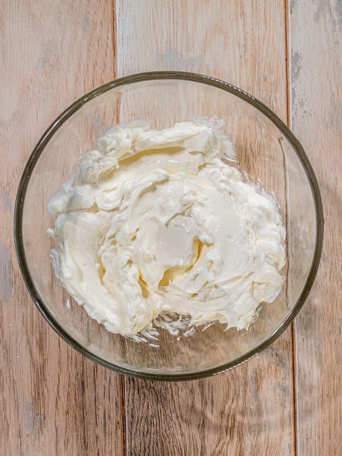 Cream cheese and sugar in a bowl.