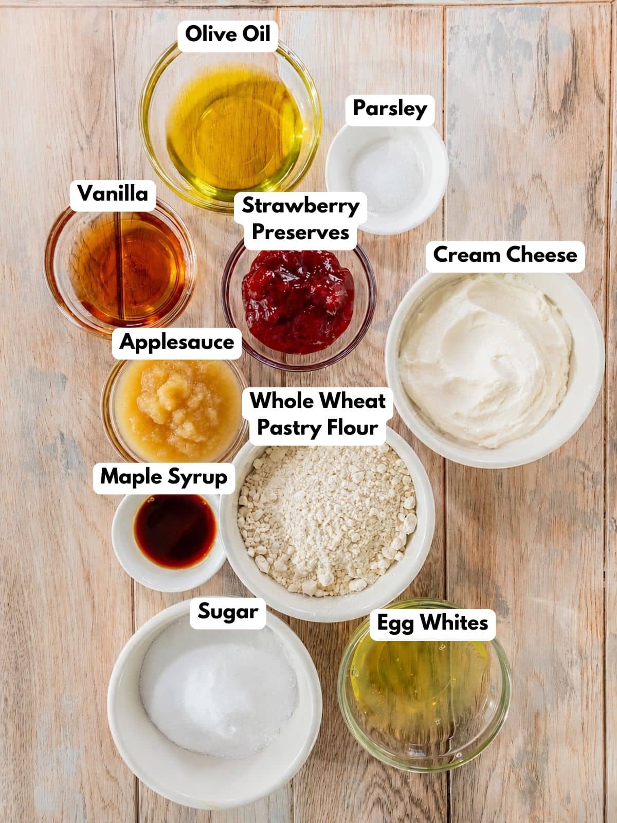 Ingredients to make strawberry cream cheese bars in bowls on a table.