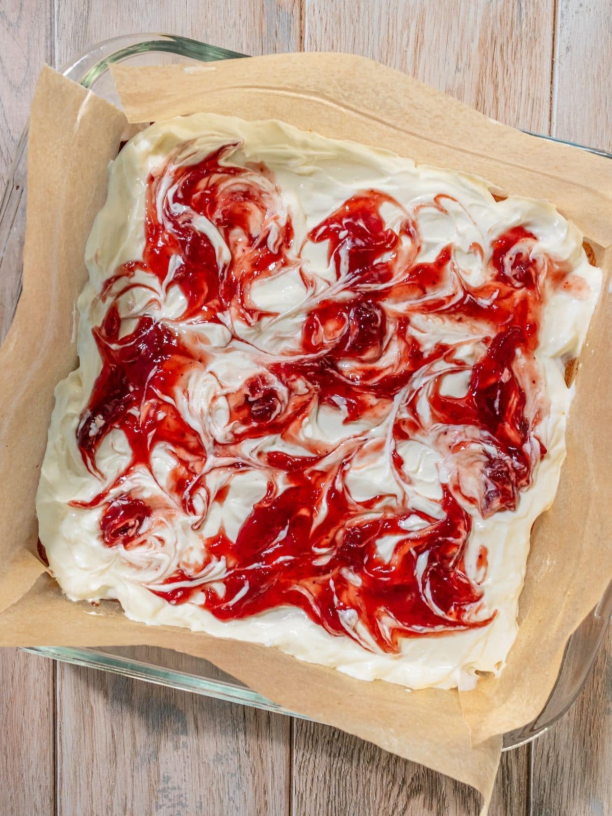 Strawberry preserves swirled on top.