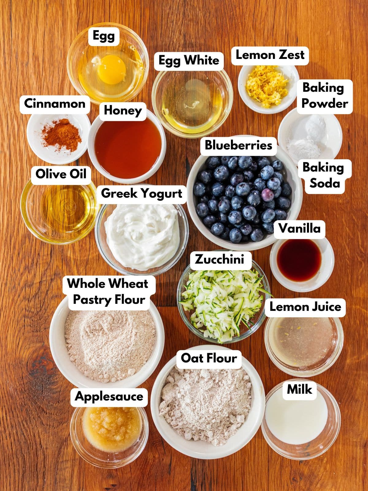 Ingredients to make this blueberry and zucchini bread in bowls on a table.