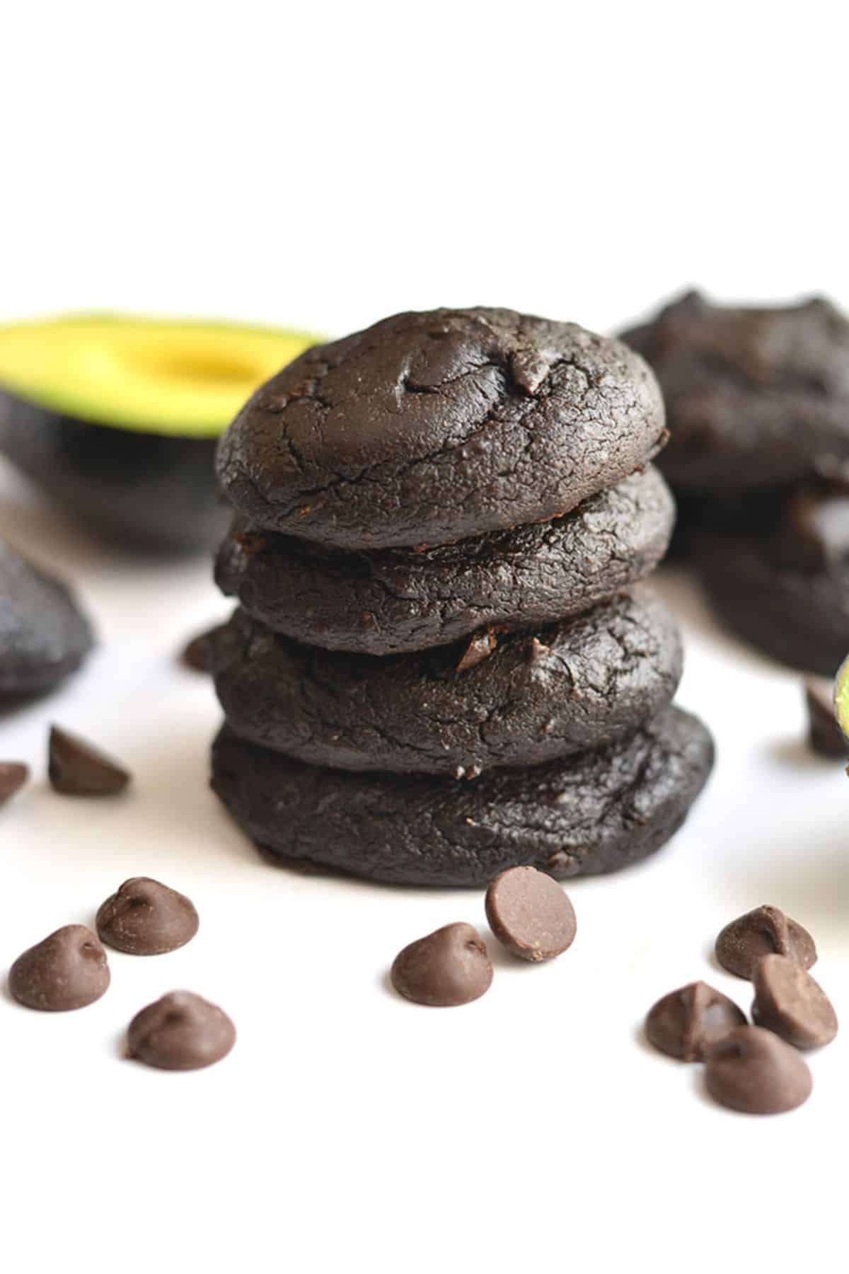 Avocado cookies stacked on top of one another.