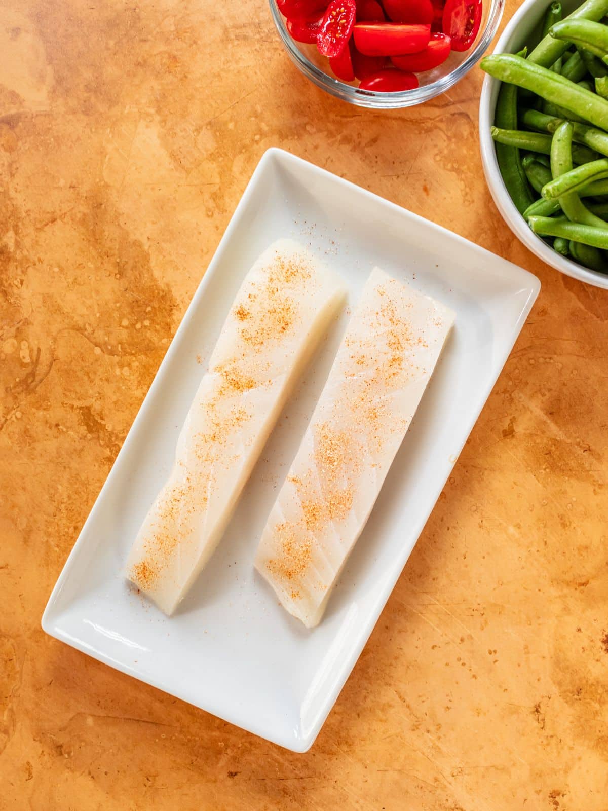 Two halibut slices on a plate.