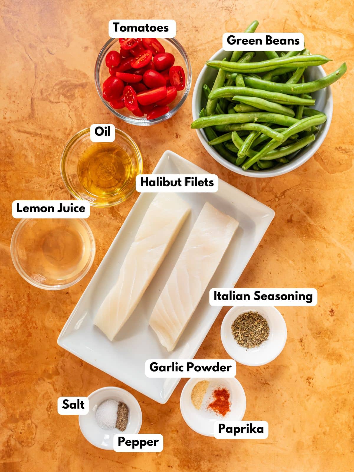 Ingredients to make this baked halibut fish on a table.