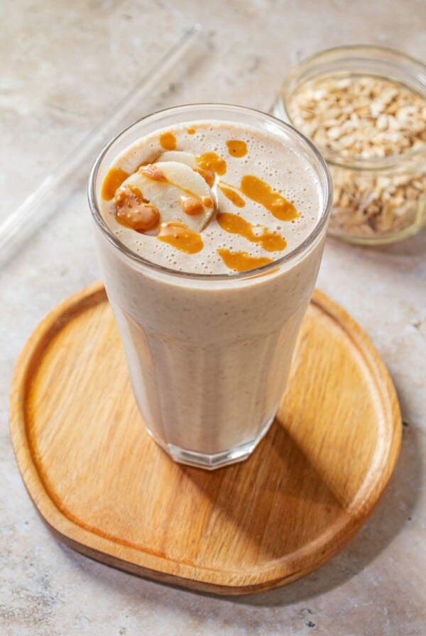 Banana smoothie on a wooden tray.