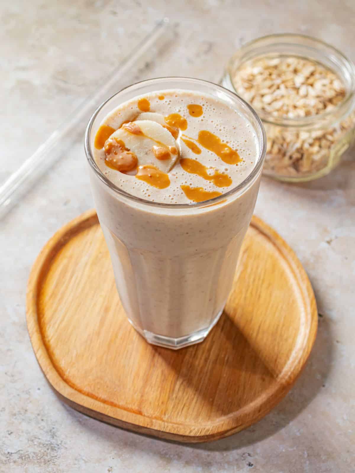 Banana smoothie on a wooden tray.