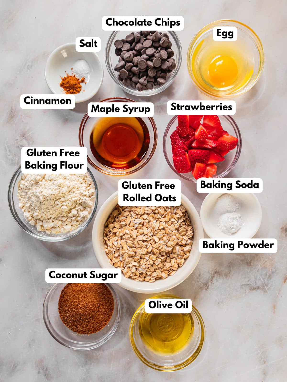 Ingredients to make this pizookie cookie in bowls on a table.