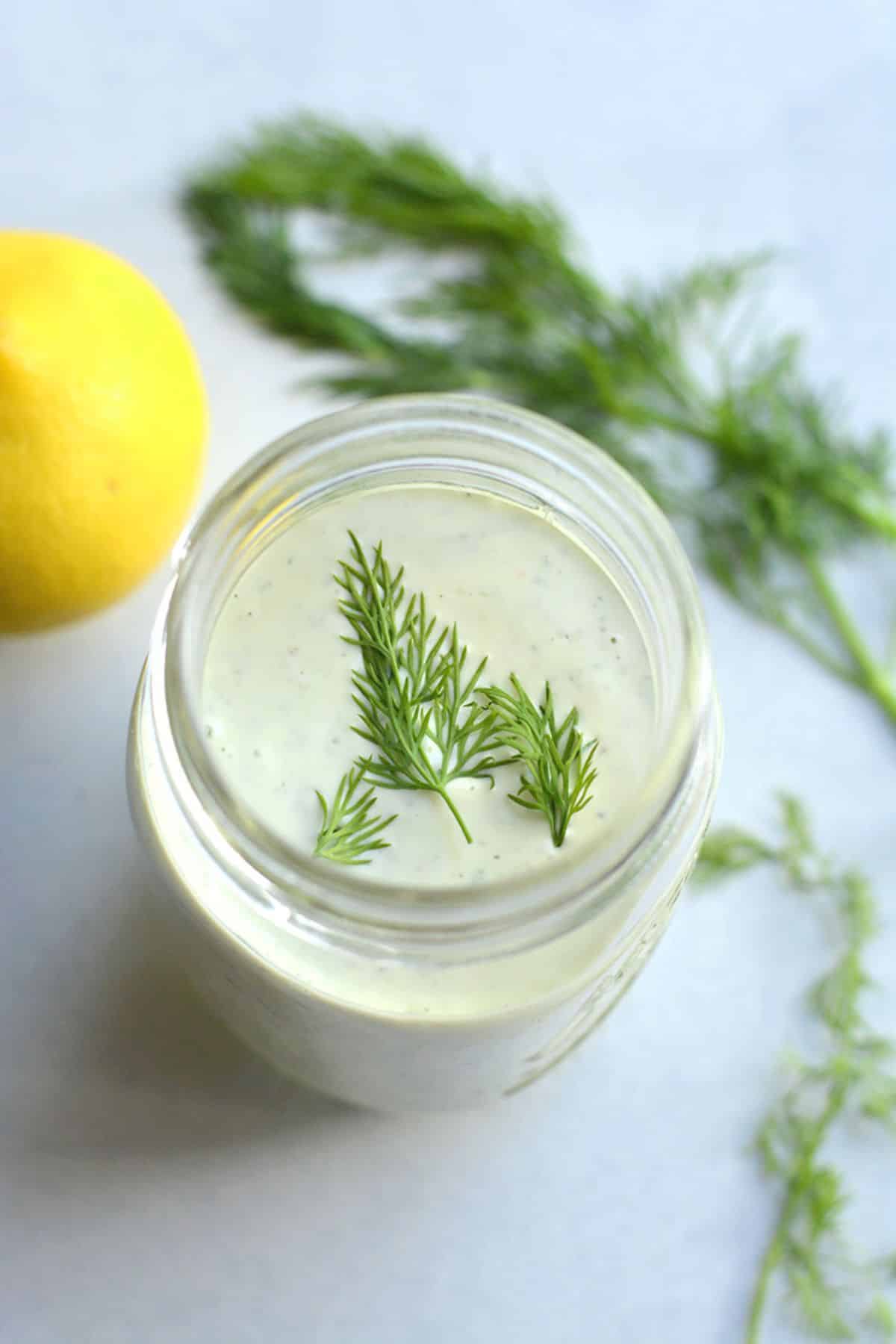 Greek yogurt ranch dressing with dill on top.