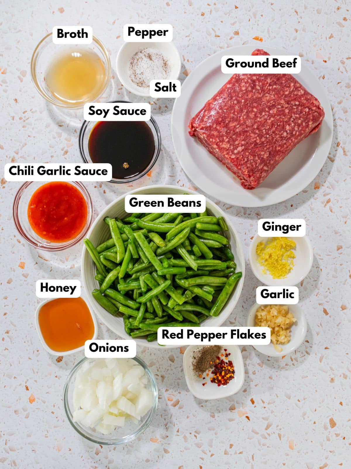 Ingredients to make this stir fry with ground beef in bowls on a table.